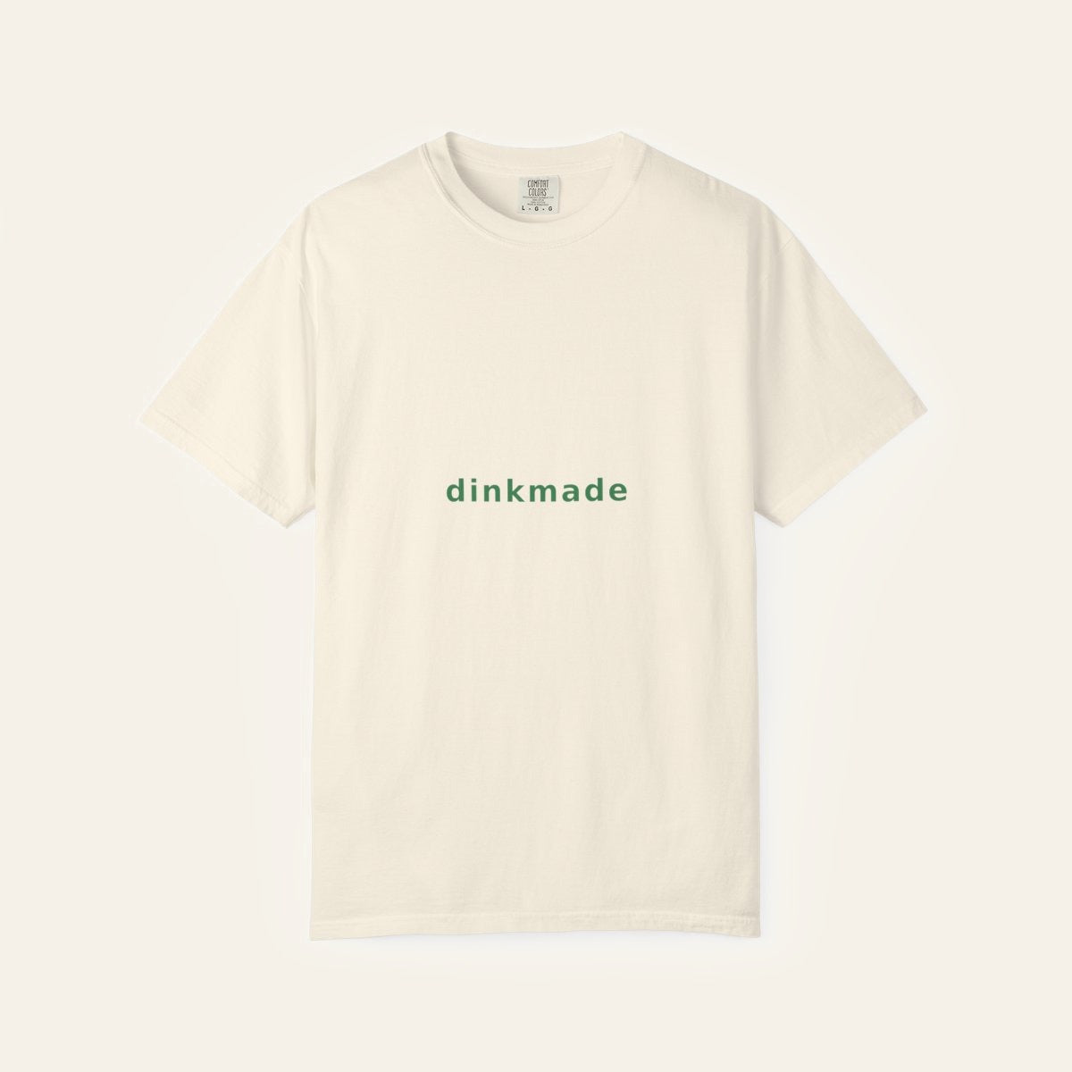 The Wordmark Tee — Court Green on Cream — product flat lay
